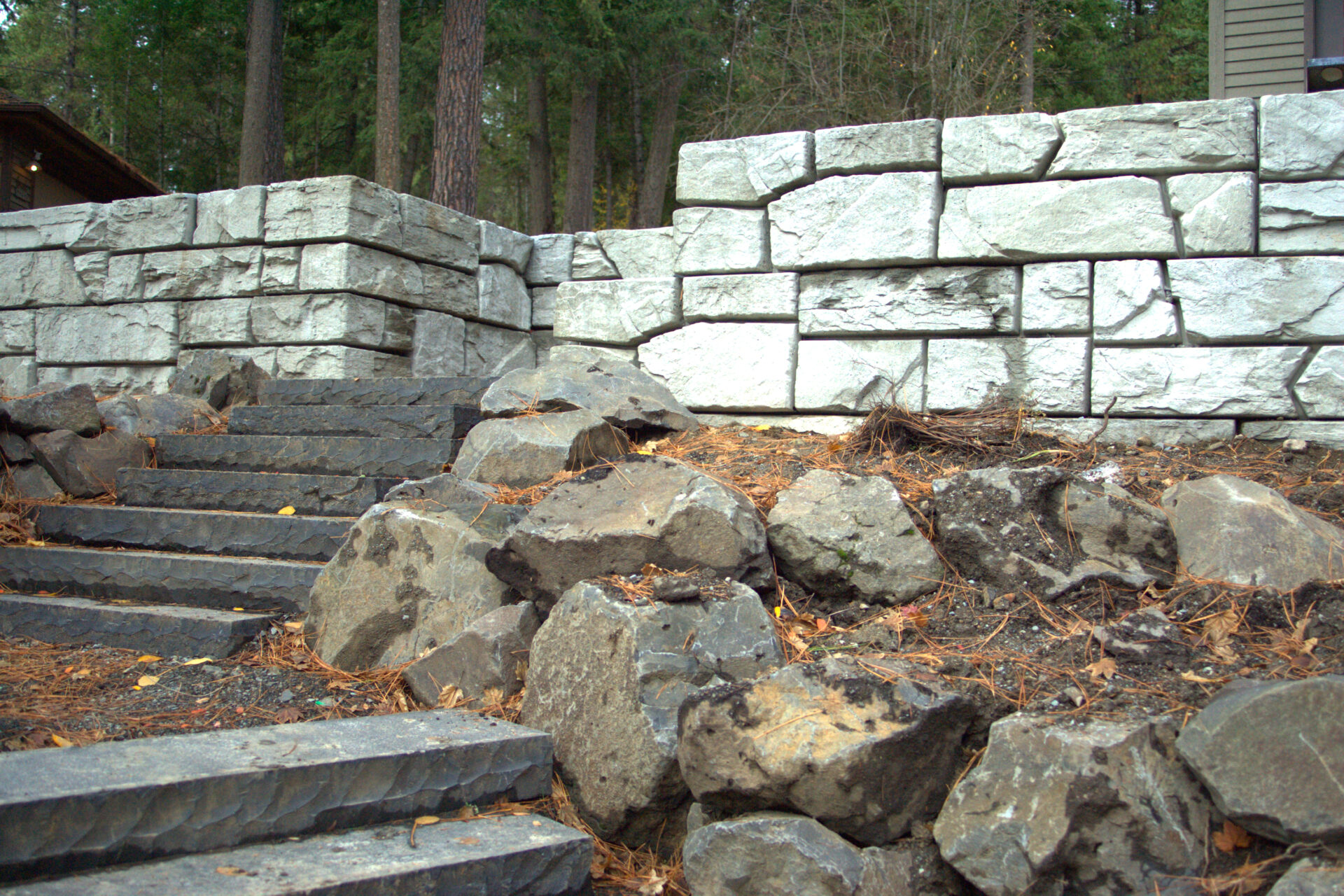 Custom hardscape stairs and block retaining wall project in Stanton by Blue Sky Decks.
