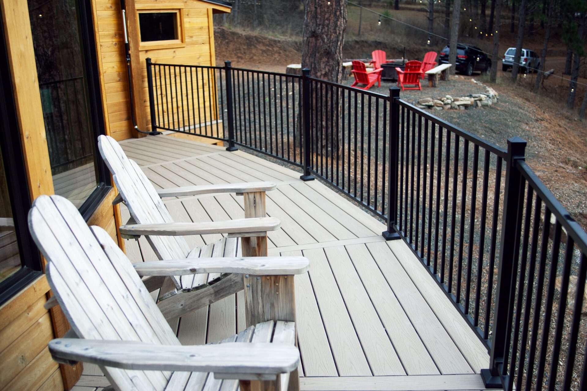 Custom composite deck with black railing at Happy Hill Yurt, built for outdoor relaxation near sauna and cold plunge area.