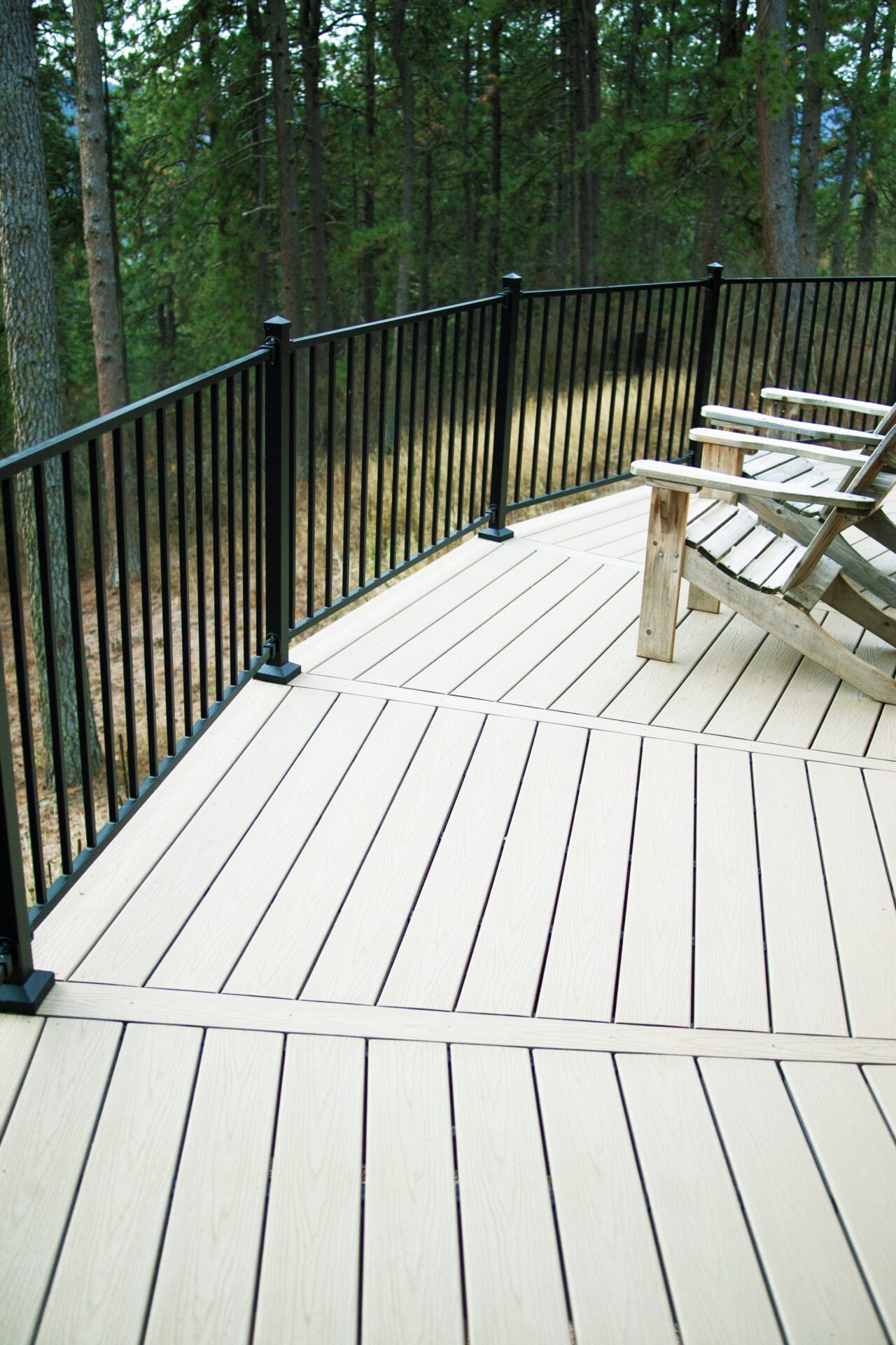 Custom composite deck with black railing at Happy Hill Yurt, built for outdoor relaxation near sauna and cold plunge area.